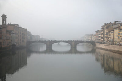 Ponte Santa Trinita in Florence, Italy taken in the midst of a dense fog by Photographer Scott Allen Wilson.