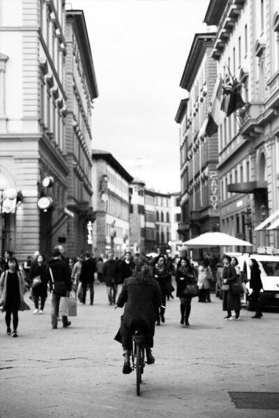 Photo of a girl in Florence, Italy riding a bicycle near piazza della repubblica by Photographer Scott Allen Wilson.