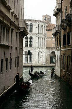 Magical print by Photographer Scott Allen Wilson, of two gondoliers navigating the narrow waterways of Venice Italy.