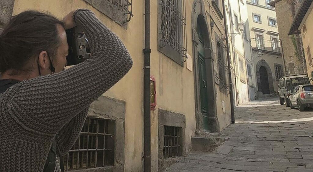 Portrait of Photographer Scott Allen Wilson taking a photography in Siena, Italy