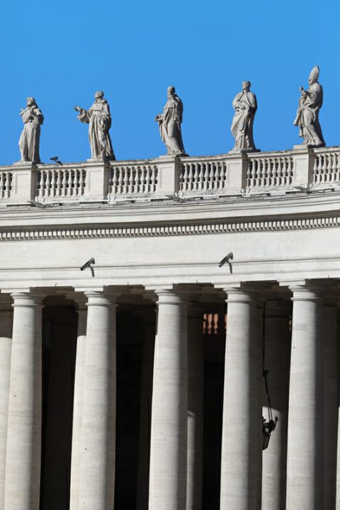 Picture of symmetric columns and gargoyles of St. Peter’s Basilica taken by Photographer Scott Allen Wilson in Rome, Italy.