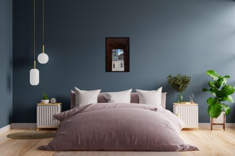 Purple and blue bedroom decoration with a wooden framed print of the Cathedral of Siena peaking out behind a brick arch taken by Photographer Scott Allen Wilson in Italy.