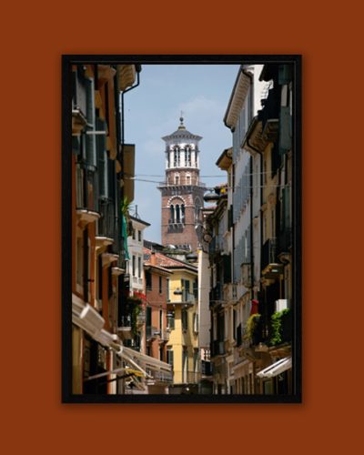 Colorful framed print of a narrow street in Verona, Italy guiding to the clocktower of Palazzo della Regione captured by Photographer Scott Allen Wilson.