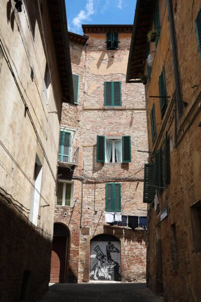 A beautiful medieval street in Siena, Italy taken by Photographer Scott Allen Wilson