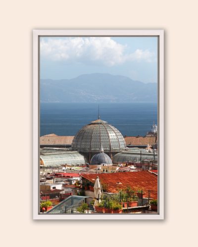 White framed print of an overlook of the Galleria Umberto I with water behind taken by Photographer Scott Allen Wilson in Naples, Italy.