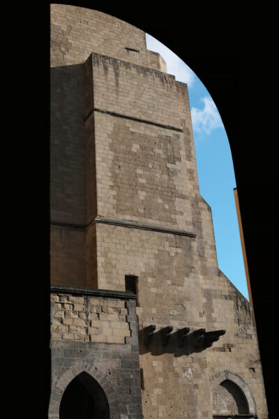 Artistic photo of the Santa Chiara religious complex in Naples, Italy behind an arched wall taken by Photographer Scott Allen Wilson