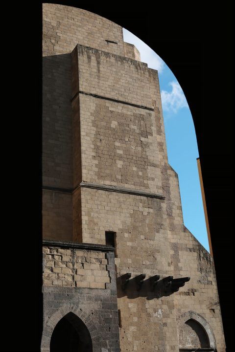 Artistic photo of the Santa Chiara religious complex in Naples, Italy behind an arched wall taken by Photographer Scott Allen Wilson