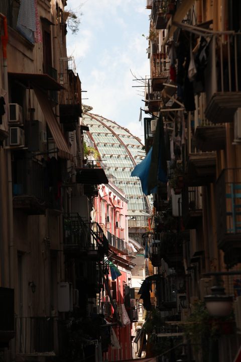Amazing photo of the dome of Galleria Umberto I between a narrow street in Naples, Italy taken by Photographer Scott Allen Wilson