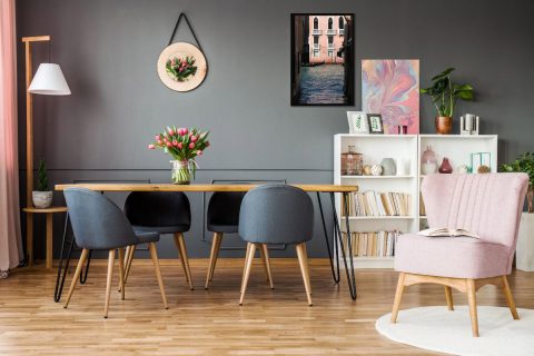 Vintage gray dining room decoration with a framed print of Venice, Italy, taken by Photographer Scott Allen Wilson, combined with pink details of the room.