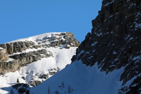 Nature photography of two jagged peaks of the Dolomites, Italy with an intense blue sky in the background taken by Photographer Scott Allen Wilson.