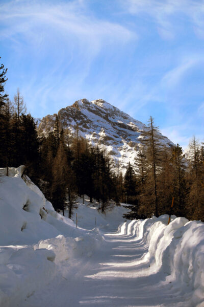 Portrait photo of a snow path leading to a snow-capped mountain of the Dolomites, Italy taken by Photographer Scott Allen Wilson.