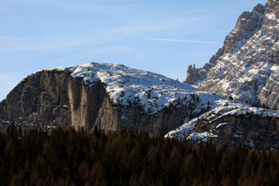 Beautiful landscape photo of the Dolomites, Italy and a pine tree forest below, taken by Photographer Scott Allen Wilson.