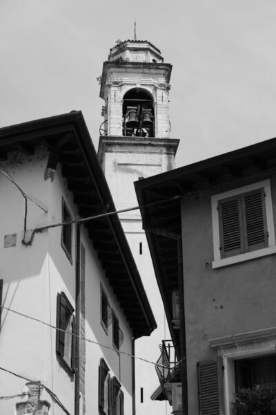 Black and white photo of the traditional architecture in Lazise, Italy taken from a low angle by Photographer Scott Allen Wilson.