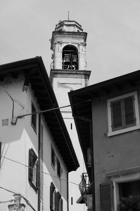 Black and white photo of the traditional architecture in Lazise, Italy taken from a low angle by Photographer Scott Allen Wilson.