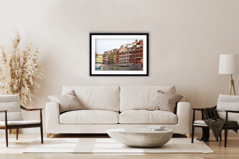 A boho chic minimal living room is flattered by a print of Vernazza, Italy. By Photographer Scott Allen Wilson.
