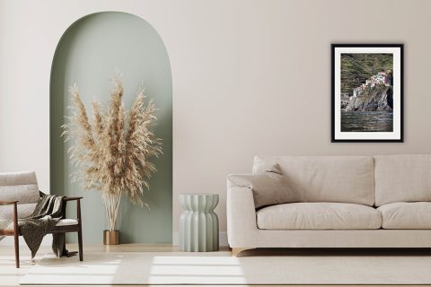 The print showing Manarola in Cinque Terre, Italy, hangs in a minimal living room. Photo by Photographer Scott Allen Wilson.