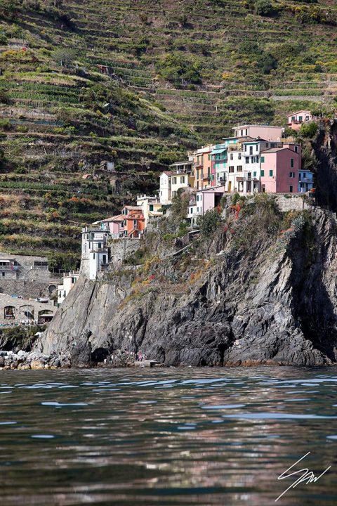 A view of Manarola in Cinque Terre, Italy, mounted up a peak over the sea. Captured by Photographer Scott Allen Wilson.