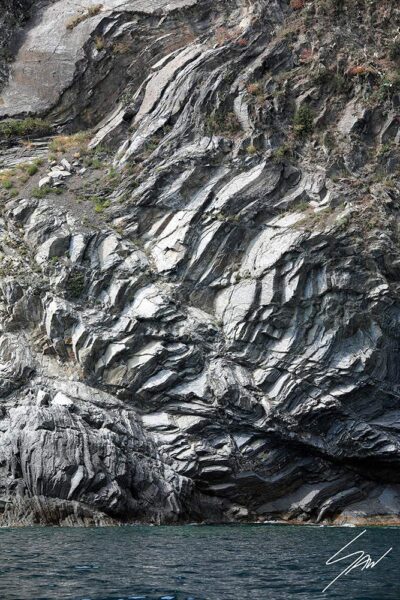 Monterosso al Mare in Cinque Terre, Italy. The sun creates interesting contrasts on a rock. By Photographer Scott Allen Wilson.