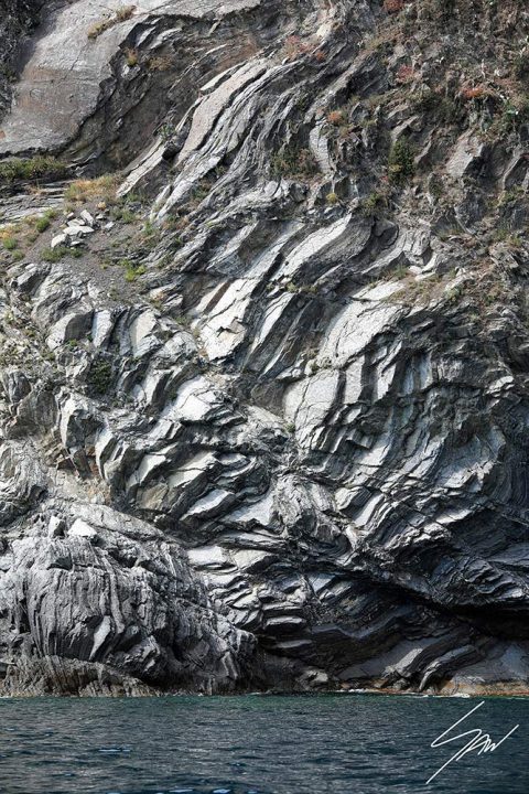 Monterosso al Mare in Cinque Terre, Italy. The sun creates interesting contrasts on a rock. By Photographer Scott Allen Wilson.