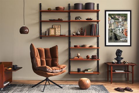 The print of Rio Maggiore, Italy, by Photographer Scott Allen Wilson, compliments a living room with leather and wooden decor.