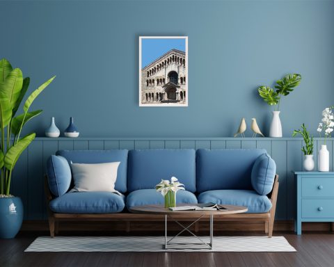 A print of the Cathedral of Santa Maria Assunta in Parma hung in a blue living room with minimal and colorful decor. By Photographer Scott Allen Wilson.