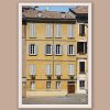 White framed print of a big yellow building with lots of windows in Parma. Created by Photographer Scott Allen Wilson