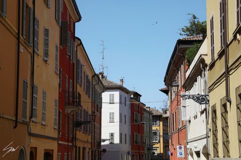 A view of the colorful buildings in Parma's streets. By Photographer Scott Allen Wilson