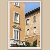 A white framed print of butter-colored buildings in Pescara, Italy. By Photographer Scott Allen Wilson.