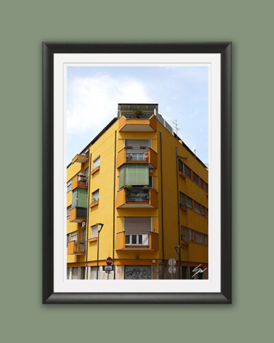 A black framed print of a symmetric yellow house in Pescara, Italy. By Photographer Scott Allen Wilson.