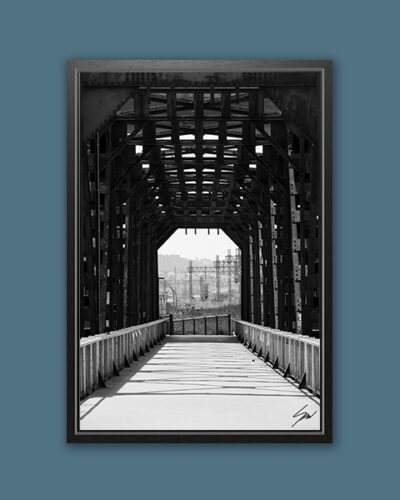 A black framed print of an iron bridge in Pescara, Italy. By Photographer Scott Allen Wilson.