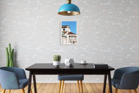 A white framed print of the Dome of Lucca, Italy, hanging in a modern kitchen. By Photographer Scott Allen Wilson.