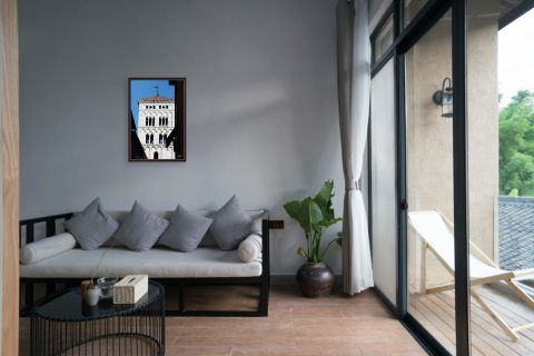 A framed print of the Church of San Michele in Foro in Lucca, Italy, hanging in a modern living room. By Photographer Scott Allen Wilson.