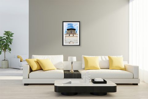 A black framed print of the Basilica di San Frediano in Lucca, Italy, hanging in a white and pastel living room. By Photographer Scott Allen Wilson.