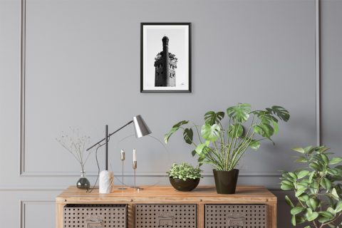 A black and white print of Torre Guinigi with trees on top of it Lucca, Italy, hanging in a minimal studio. By Photographer Scott Allen Wilson.