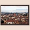 A dark brown framed print of a view of the city of Lucca, Italy. By Photographer Scott Allen Wilson.