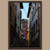 A dark brown framed print of Torre Guinigi in the city of Lucca, Italy, with some bell towers visible. By Photographer Scott Allen Wilson.