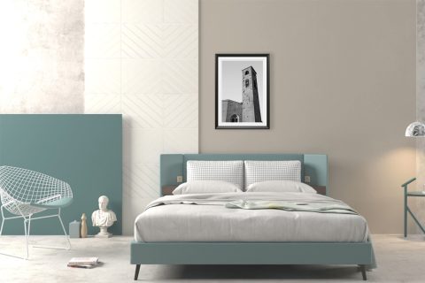 A black framed print of San Francesco Church in Lucca, Italy, hanging in a minimal bedroom. By Photographer Scott Allen Wilson.