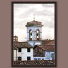 A dark brown framed print of a bell tower and red tiled rooftops in the city of Lucca, Italy. By Photographer Scott Allen Wilson.