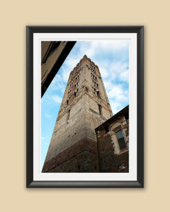 A black framed print of a brick tower in the city of Lucca, Italy. By Photographer Scott Allen Wilson.