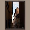 A dark brown framed print of rooftops in Lucca, Italy. By Photographer Scott Allen Wilson.