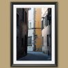 A black framed print of a view of Via Del Toro in the city of Lucca, Italy. By Photographer Scott Allen Wilson.