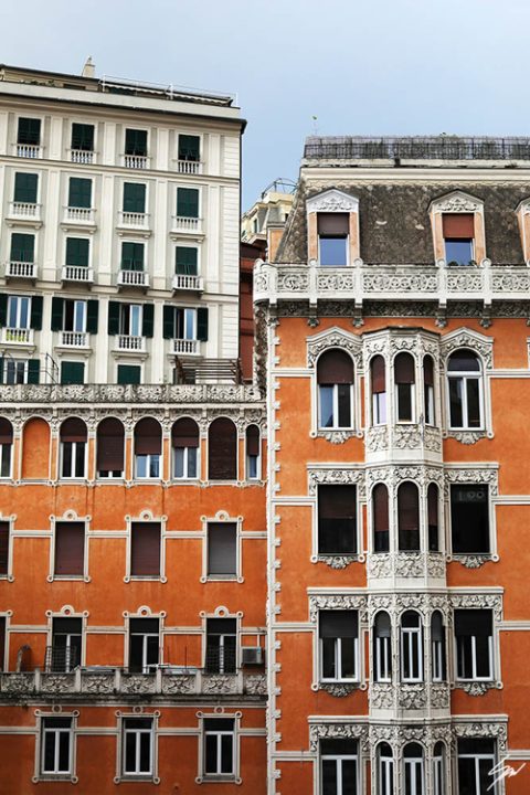 Finely decorated windows on a bright orange historical residence. Photo captured by Travel Photographer Scott Allen Wilson.