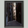 Wooden framed artistic print of a historical city alley, winding across imposing structures. Photo captured in Genova, Italy, by Travel Photographer Scott Allen Wilson.