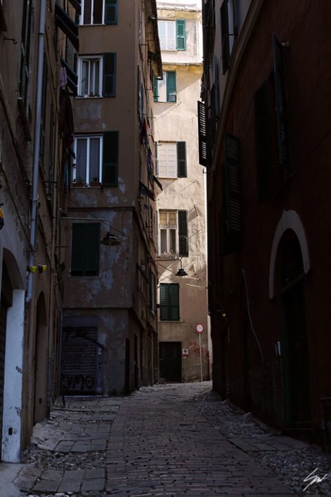 Old cobblestone path stretches between time-worn residential blocks. Photo captured by Travel Photographer Scott Allen Wilson.