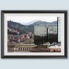 A black frame with a white passe-partout surrounds a work of art created by Travel Photographer Scott Allen Wilson. The subject is a landscape of Genova, Italy, which focuses on a mix of historical buildings, and a reflective modern skyscraper as well.
