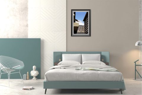 The neutral grey of the concrete, together with the geometrical shapes of the buildings, ideally match the ash tone in this room’s walls, while it contrasts beautifully with the natural curves of the plants.