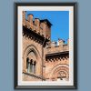 Fine art framed print of a crenellated historic brick facade with Gothic arched windows against a deep blue sky, Matter + Time by Scott Allen Wilson, available in 8x12 and 16x24.
