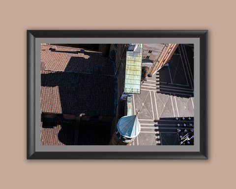 Fine art framed print of a dramatic aerial view of a historic Italian piazza with geometric shadows and terracotta rooftops, Slash by Scott Allen Wilson, available in 8x12 and 16x24.