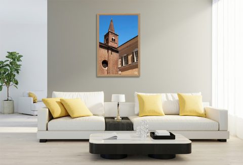 Shutter by Scott Allen Wilson framed travel print displayed on a living room wall above two white sofas.