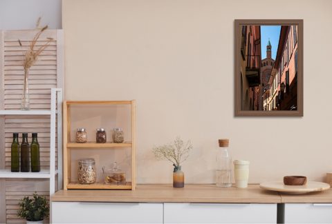 Sorbet and Sunrays by Scott Allen Wilson framed travel print displayed on a kitchen wall above a wooden counter.